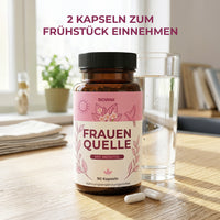 Thumbnail for Biovana Frauenquelle Inositol-Kapseln mit Hinweis 2 Kapseln zum Frühstück, Wasserglas und Tisch