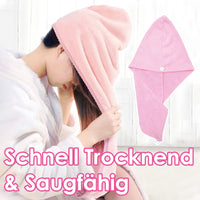 Thumbnail for Frau mit weißem Bademantel legt rosa Haartuch über nasses Haar, daneben gefaltetes Haartuch
