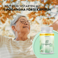 Thumbnail for Ältere Frau mit Brille hebt die Arme, daneben Lipogandha Forte Dose vor herbstlichem Hintergrund